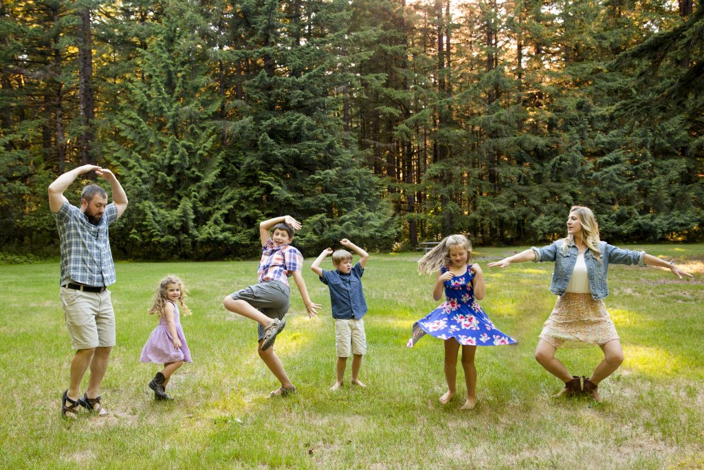 family of six dancing outdoors